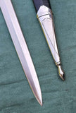 Close-up of the blade and pommel of a European knight hand and a half longsword, showcasing intricate details.