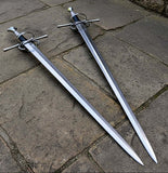 European hand and a half longsword displayed on stone surface, showcasing its intricate design and historical craftsmanship.