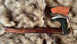 Short Viking Bearded Axe with leather edge cover on a fur background.