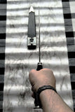 Scottish Long Dirk held by hand, showcasing the sleek Damascus blade and elegant ebony grip.