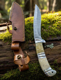 Replica Persian Fighting Knife with Damascus Blade Man At Arms displayed with leather sheath and intricate handle design