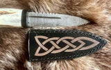 Hand forged sgian dubh with Damascus blade and leather sheath featuring Celtic design.