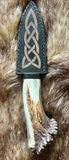 Hand forged sgian dubh with a decorative leather sheath and crown stag handle, showcasing traditional Scottish craftsmanship.
