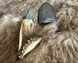 Crown Stag knife with decorative leather sheath on a fur background