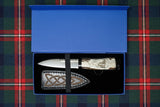 A hand-carved antler Sgian Dubh knife with a blade made of tempered carbon steel, displayed in a beautiful blue gift box with a cow leather sheath.