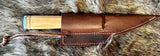 Norse Viking Utility Scramasax Damascus Blade with olive wood handle and leather sheath on fur background.