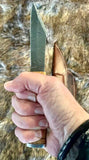 Norse Viking Utility Scramasax Damascus Blade held in hand, showcasing the unique design and olive wood handle.