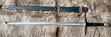 Hand forged Crecy sword displayed with scabbard on fur background.
