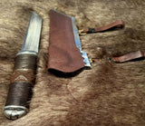 Hjalmar Viking Seax Knife handmade with leather sheath on fur background.