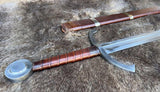 The Bedford Medieval War Sword displayed on fur with its scabbard, showcasing intricate design and craftsmanship.