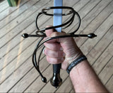 Hand gripping an ambidextrous renaissance rapier, showcasing its unique guard design and craftsmanship.