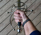 Close-up of a hand grasping a renaissance rapier with ornate hilt details, perfect for ambidextrous use.