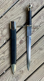 Main Gauche Parrying Dagger by Man at Arms displayed with sheath on wooden surface.