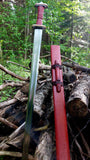 Migration Era Sword displayed outdoors alongside a wooden sheath, highlighting detailed craftsmanship.