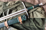 LOTR Strider Ranger sword replica by Kingdom Of Arms resting on a green cloak with a detailed scabbard.
