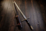 Sword with sheath on a wooden surface