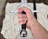 Hand holding a side-sword with a decorative hilt against a neutral background