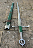 Irish hand and a half sword by Kingdom Of Arms displayed with scabbard on stone surface.