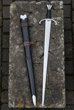 Medieval Arming sword with sheath on a textured surface