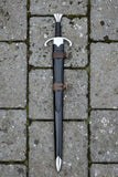 Beautiful Arming Sword with sheath on a textured stone background