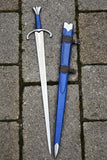 Medieval Arming sword with blue sheath on a stone surface