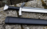 Medieval Bowman Sword displayed on a stone surface with a leather sheath, showcasing its hand-forged craftsmanship.