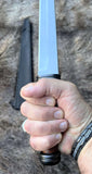 Irish Scian being held in hand, showcasing the blade and handle detail.